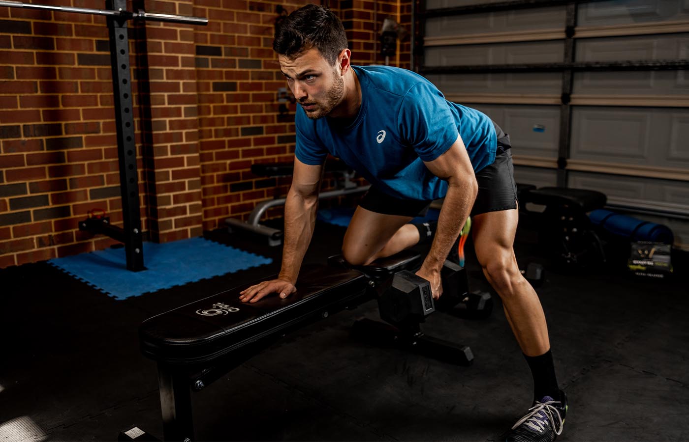A male athlete doing a dumbbell row exercise for back strength